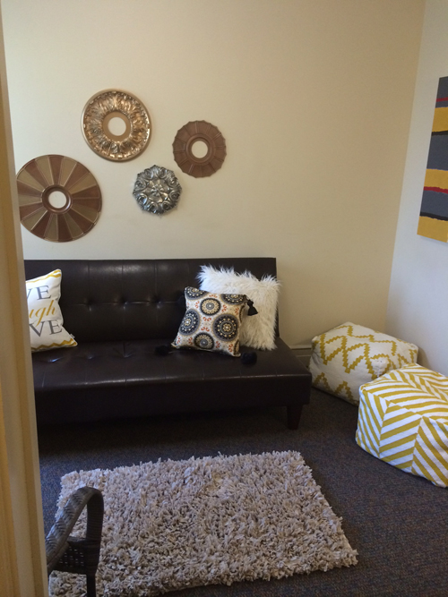 I love these floor poufs!! Jessica spray painted ceiling medallions and placed them on the wall!
