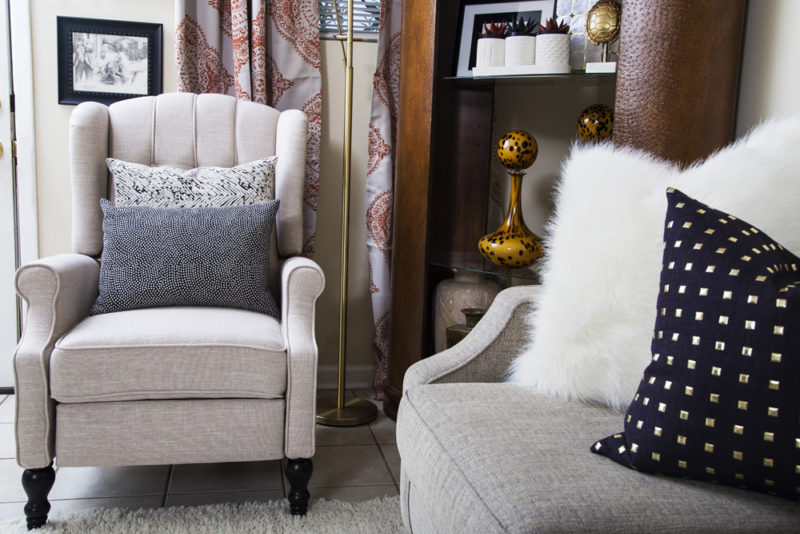 neutral living room | cream recliner | gold studs pillow | leather bookcase | neutral with pop of orange | britt smith photography