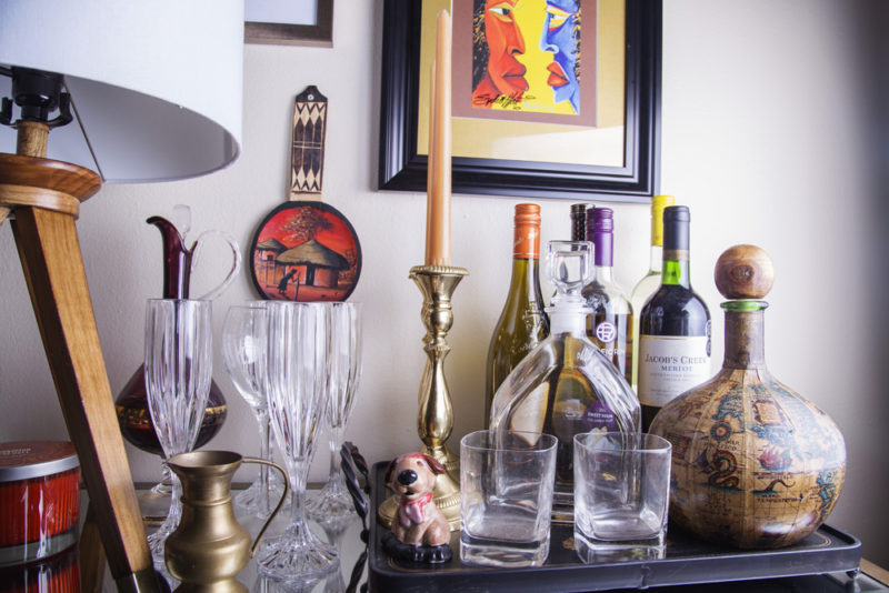 neutral living room | bar cart | dresser used as bar cart | eclectic bar cart | colorful art over bar cart | britt smith photography