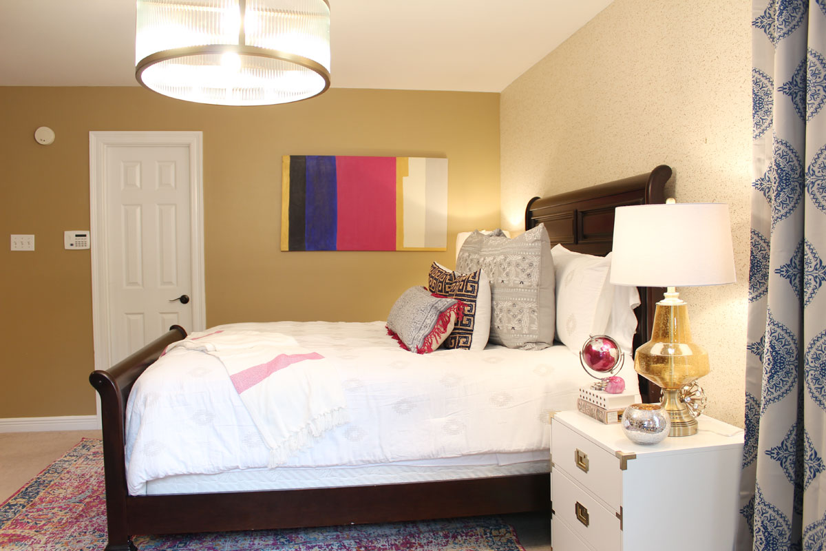 pink and blue transitional bedroom | blue bedroom | pink bedroom | transitional bedroom | glam bedroom | pink diy art | how to transform a master bedroom | white campaign dresser | blue chaise | nate berkus bedding