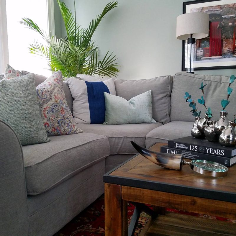 whitney j decor | transitional living room | green living room walls | light green paint color | pottery barn sectional | palm tree in living room