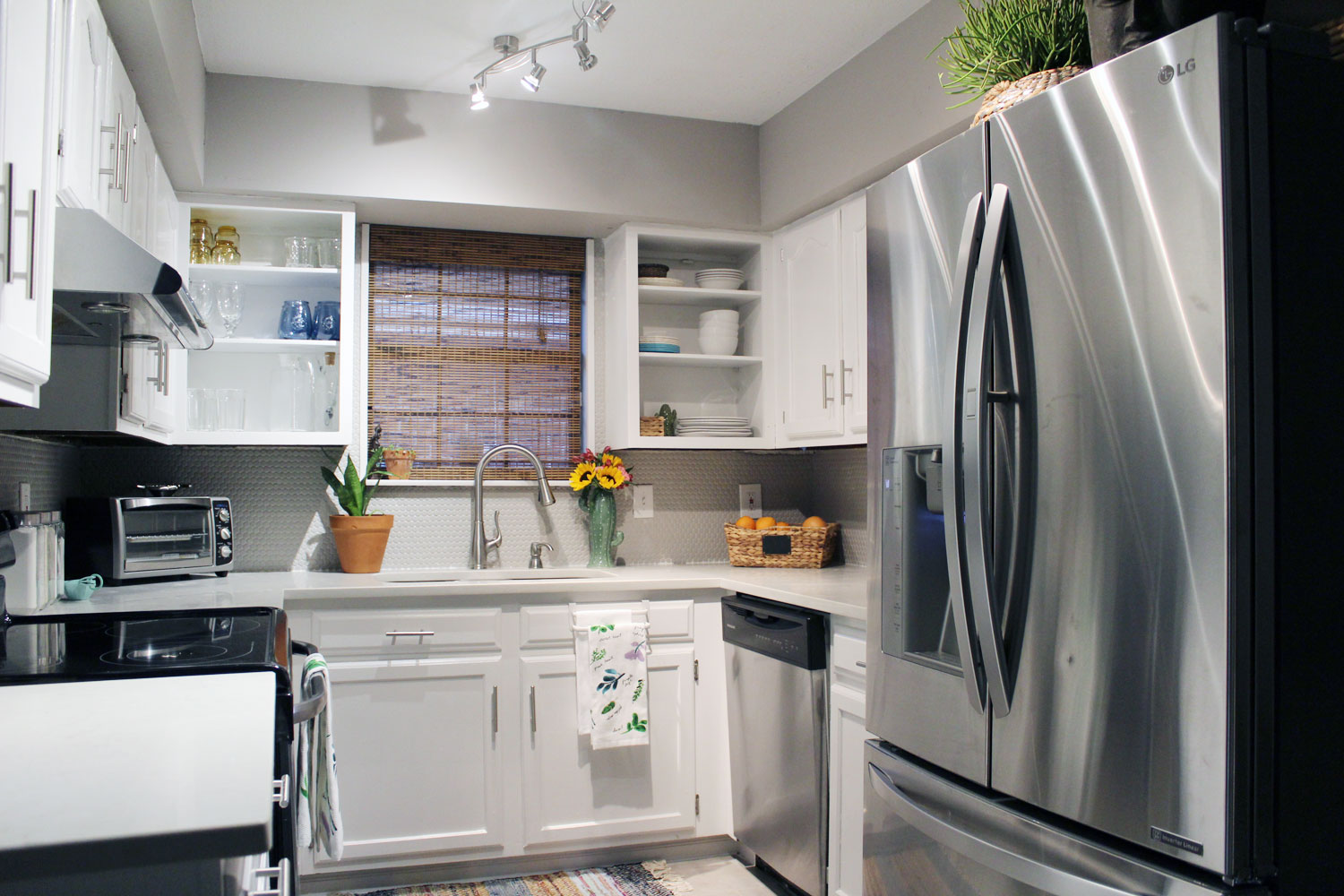 caesarstone london grey countertops | caesarstone countertops | gray and white kitchen reveal whitney j decor | caesarstone countertops | gray and white kitchen | small gray kitchen | small galley kitchen | small white kitchen | small space kitchens | tiny kitchen decor | gray and white kitchen decor | white kitchen decor | new orleans interior design | new orleans decor | new orleans homes | nola homes | nola decorator | new orleans decorator