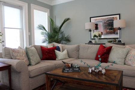 red and blue transitional living room | whitney j decor | new orleans homes | nola decor | red pillows | green walls | sherwin williams oyster gray on the walls | vintage red rug | pottery barn sectional | convertible coffee table | new orleans interior designer | new orleans decorator | new orleans blogger | nola interior designer | nola decorator | nola blogger