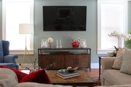 red and blue transitional living room | whitney j decor | new orleans homes | nola decor | red pillows | green walls | sherwin williams oyster gray on the walls | vintage red rug | pottery barn sectional | convertible coffee table | new orleans interior designer | new orleans decorator | new orleans blogger | nola interior designer | nola decorator | nola blogger