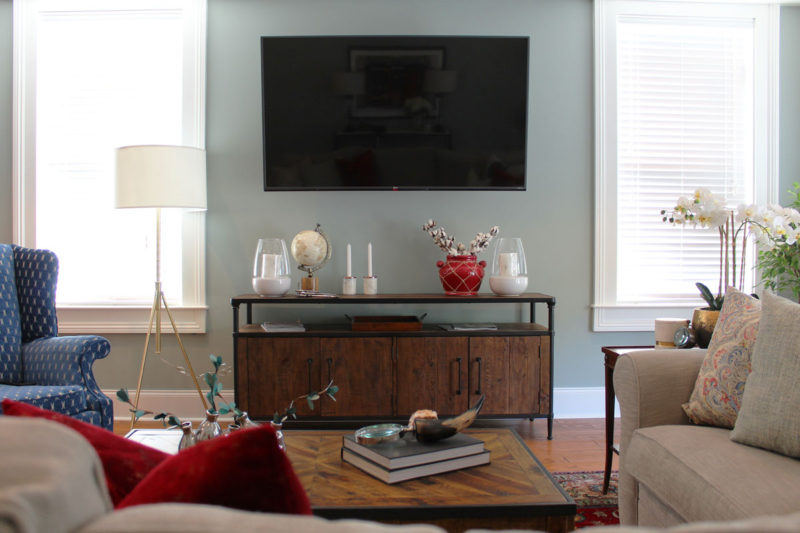 red and blue transitional living room | whitney j decor | new orleans homes | nola decor | red pillows | green walls | sherwin williams oyster gray on the walls | vintage red rug | pottery barn sectional | convertible coffee table | new orleans interior designer | new orleans decorator | new orleans blogger | nola interior designer | nola decorator | nola blogger