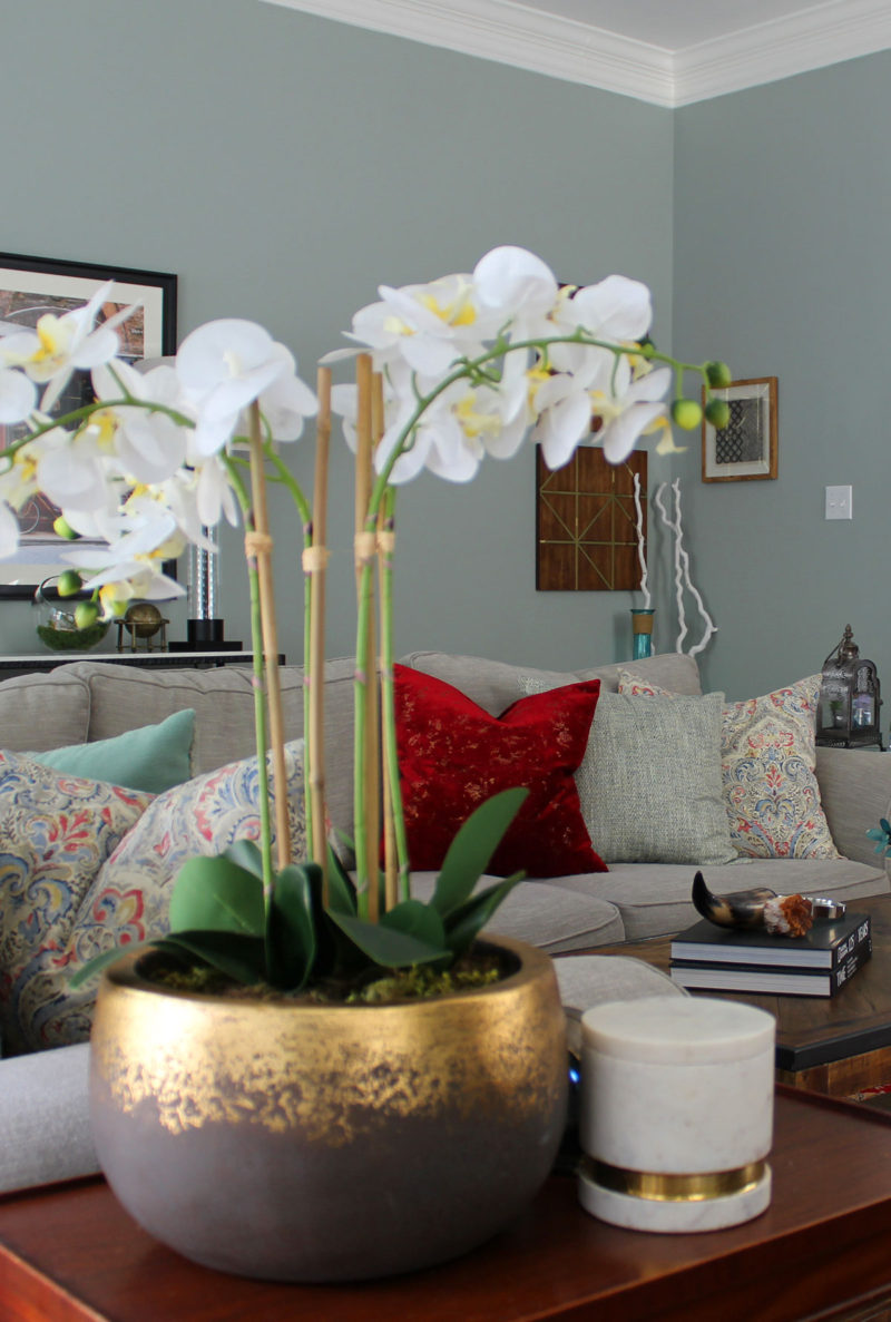 red and blue transitional living room | whitney j decor | new orleans homes | nola decor | red pillows | green walls | sherwin williams oyster gray on the walls | vintage red rug | pottery barn sectional | convertible coffee table | new orleans interior designer | new orleans decorator | new orleans blogger | nola interior designer | nola decorator | nola blogger