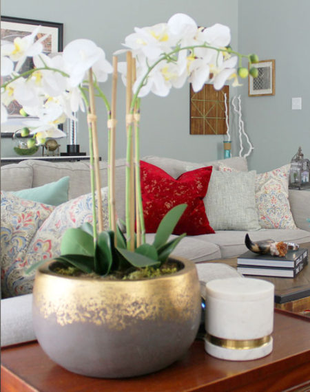 red and blue transitional living room | whitney j decor | new orleans homes | nola decor | red pillows | green walls | sherwin williams oyster gray on the walls | vintage red rug | pottery barn sectional | convertible coffee table | new orleans interior designer | new orleans decorator | new orleans blogger | nola interior designer | nola decorator | nola blogger