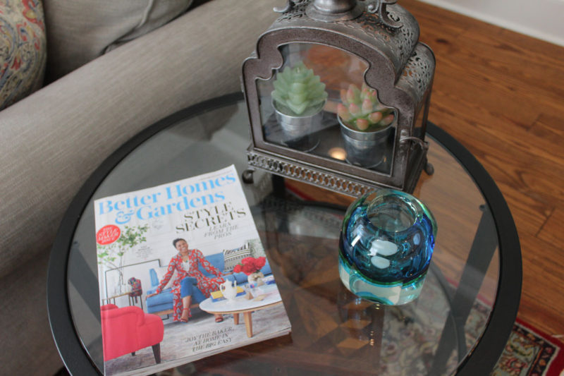 red and blue transitional living room | whitney j decor | new orleans homes | nola decor | red pillows | green walls | sherwin williams oyster gray on the walls | vintage red rug | pottery barn sectional | convertible coffee table | new orleans interior designer | new orleans decorator | new orleans blogger | nola interior designer | nola decorator | nola blogger