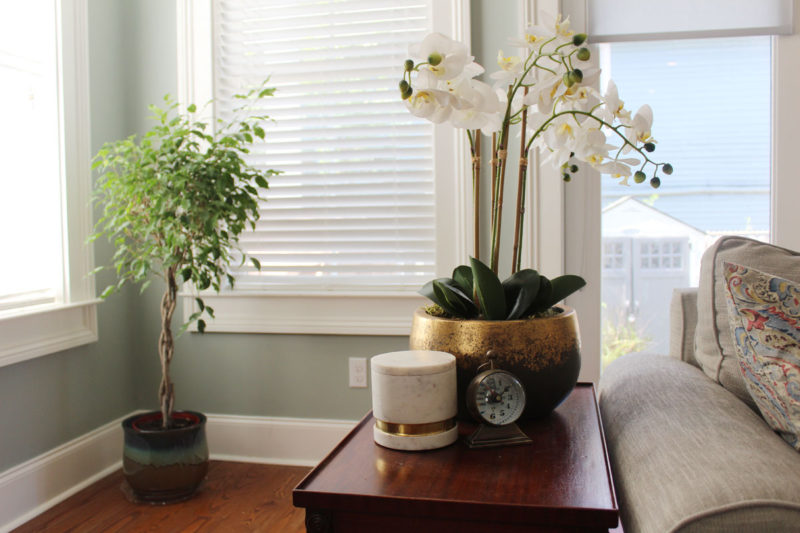 red and blue transitional living room | whitney j decor | new orleans homes | nola decor | red pillows | green walls | sherwin williams oyster gray on the walls | vintage red rug | pottery barn sectional | convertible coffee table | new orleans interior designer | new orleans decorator | new orleans blogger | nola interior designer | nola decorator | nola blogger