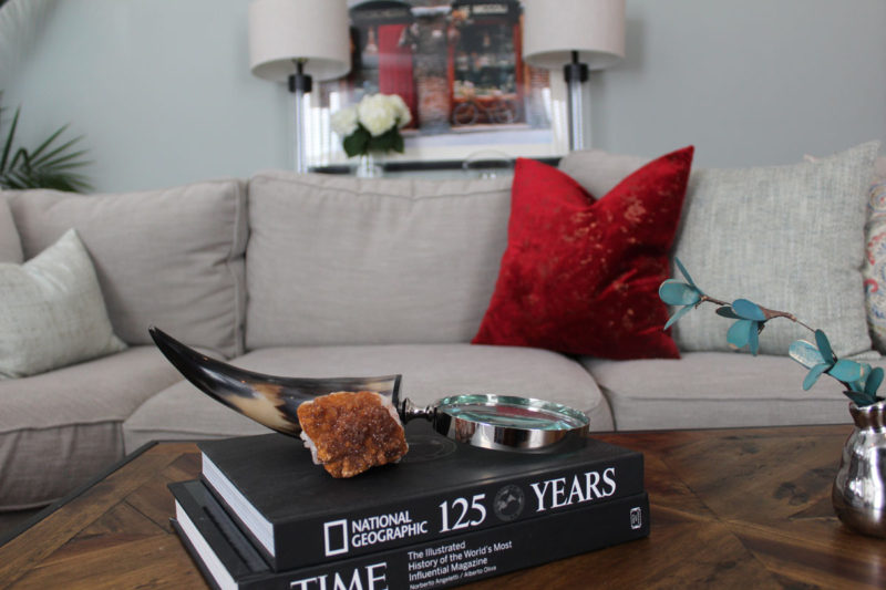 red and blue transitional living room | whitney j decor | new orleans homes | nola decor | red pillows | green walls | sherwin williams oyster gray on the walls | vintage red rug | pottery barn sectional | convertible coffee table | new orleans interior designer | new orleans decorator | new orleans blogger | nola interior designer | nola decorator | nola blogger