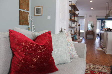red and blue transitional living room | whitney j decor | new orleans homes | nola decor | red pillows | green walls | sherwin williams oyster gray on the walls | vintage red rug | pottery barn sectional | convertible coffee table | new orleans interior designer | new orleans decorator | new orleans blogger | nola interior designer | nola decorator | nola blogger