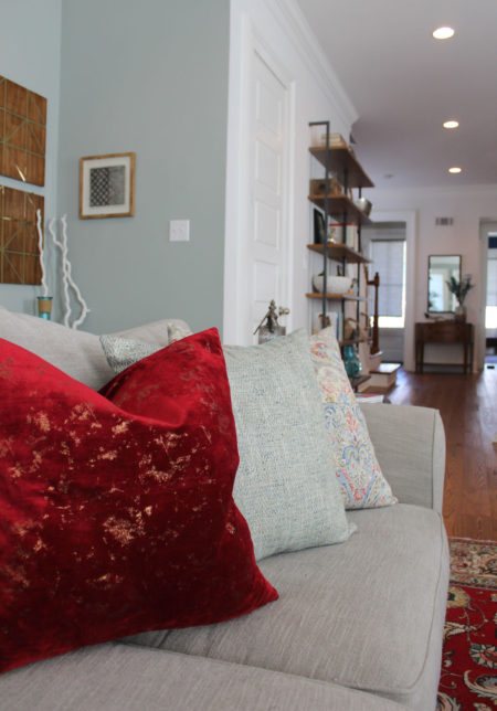 red and blue transitional living room | whitney j decor | new orleans homes | nola decor | red pillows | green walls | sherwin williams oyster gray on the walls | vintage red rug | pottery barn sectional | convertible coffee table | new orleans interior designer | new orleans decorator | new orleans blogger | nola interior designer | nola decorator | nola blogger