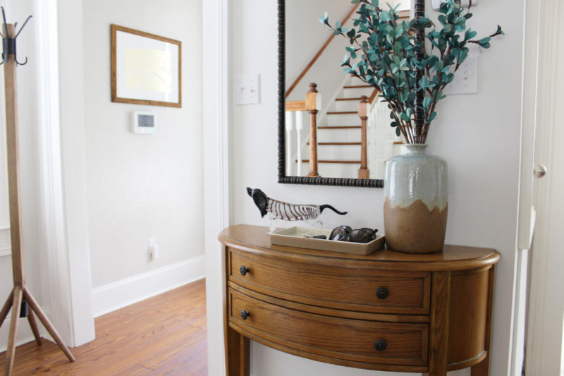 white transitional entryway with wallpaper