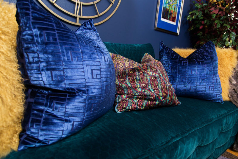 blue walls and blue pillows on green sofa