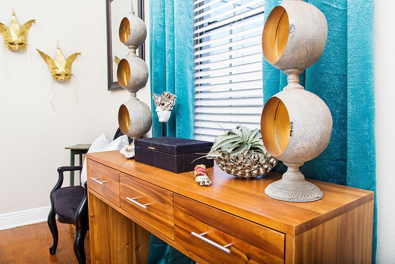 wood console table and teal curtains