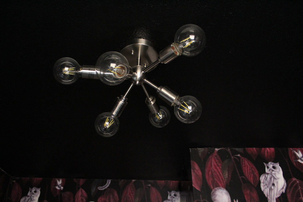 bold wallpaper and sputnik light fixture