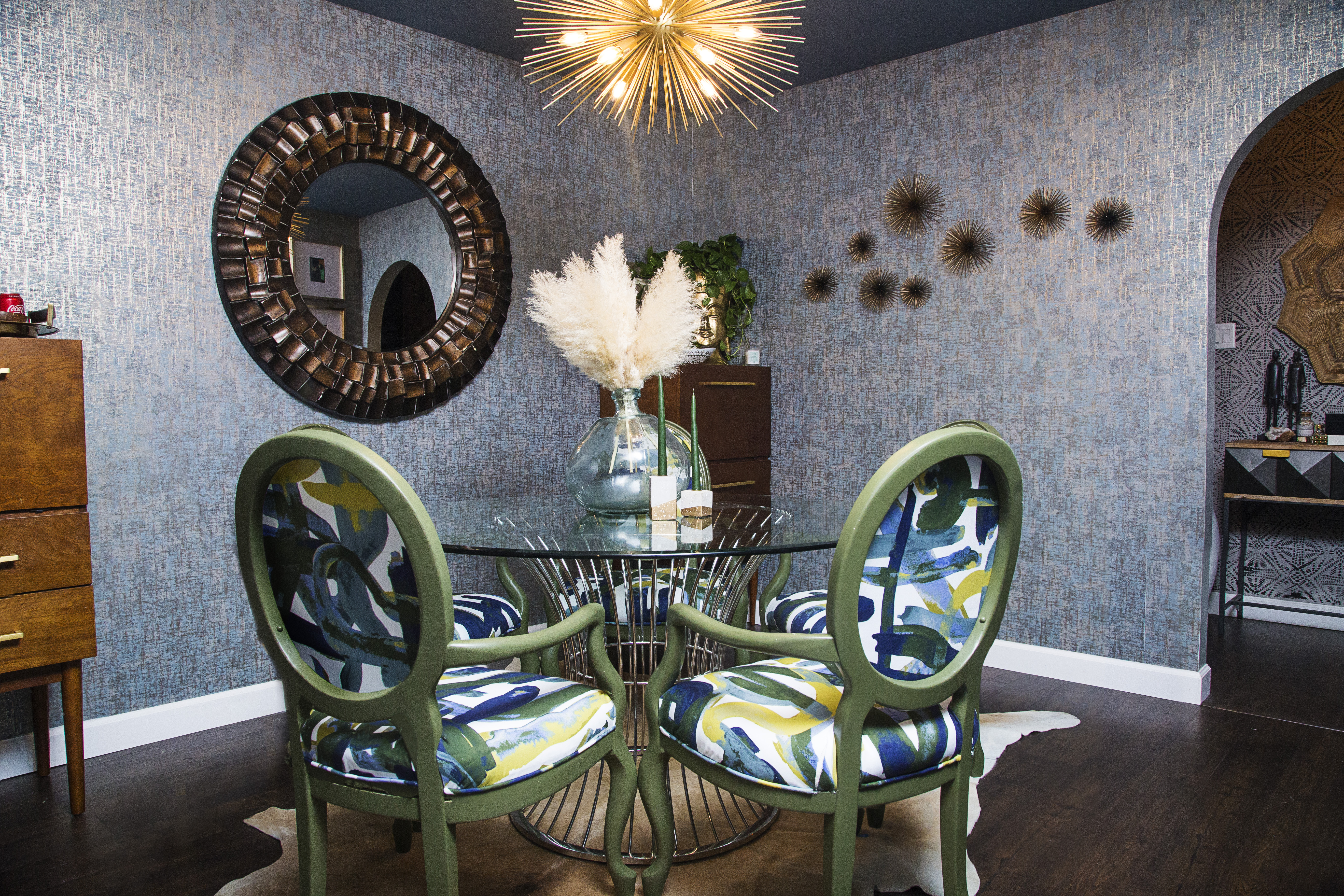 bold blue dining room with green graffiti dining chairs