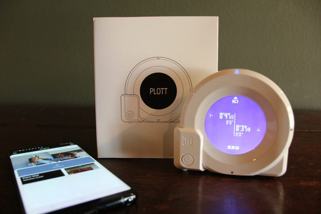 photo of the Plott app and cubit tool on a piano