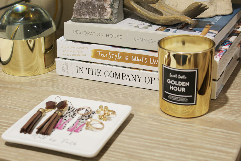 books and decor on top of a nightstand, styling a nightstand