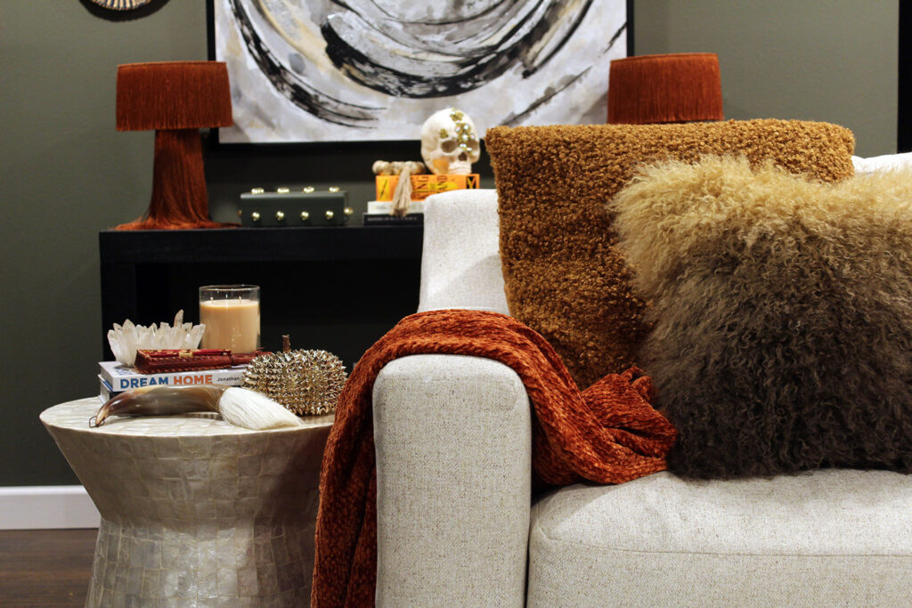 fall decor inspiration - burnt orange throw with capiz table and black table and white art in the background